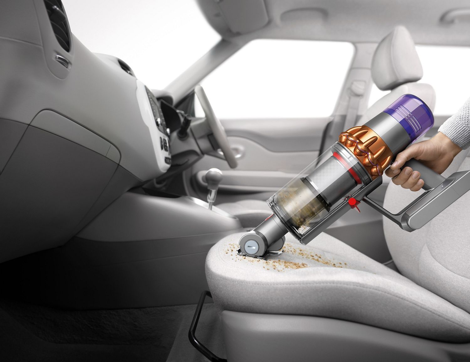 Dyson V11 being used to clean the car
